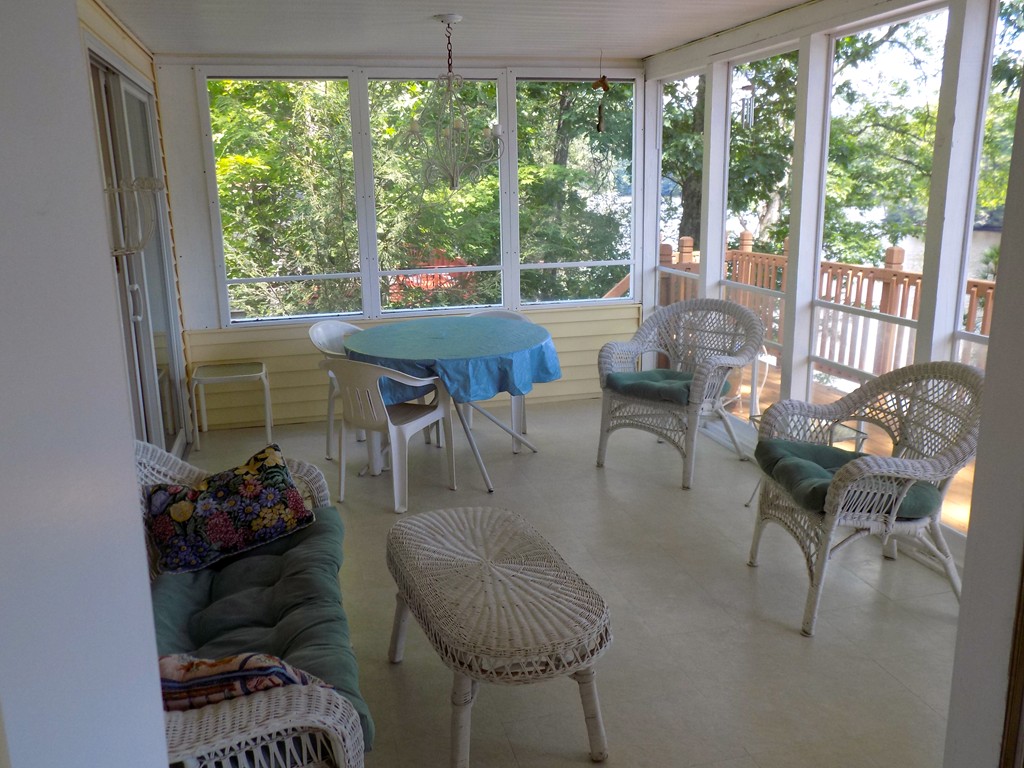 101 Sandy Beach Road Holland, MA 01521 - Photo 21 of 23 a living room with furniture and a floor to ceiling window