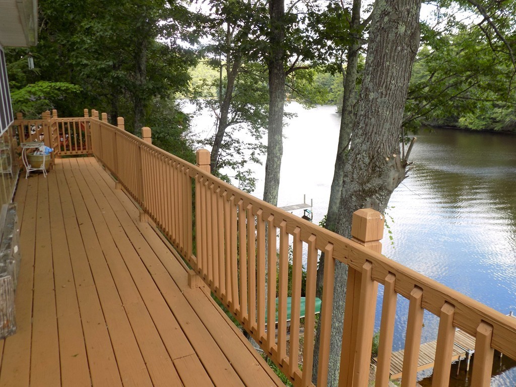 101 Sandy Beach Road Holland, MA 01521 - Photo 4 of 23 a view of balcony with wooden floor and lake view