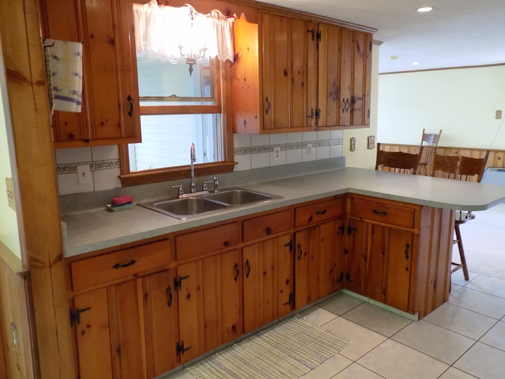 101 Sandy Beach Road Holland, MA 01521 - Photo 6 of 23 a kitchen with stainless steel appliances granite countertop a sink and a cabinets