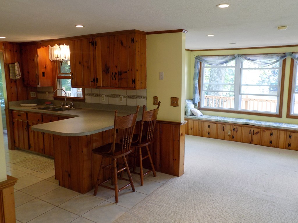 101 Sandy Beach Road Holland, MA 01521 - Photo 7 of 23 a kitchen with a stove a sink and a refrigerator