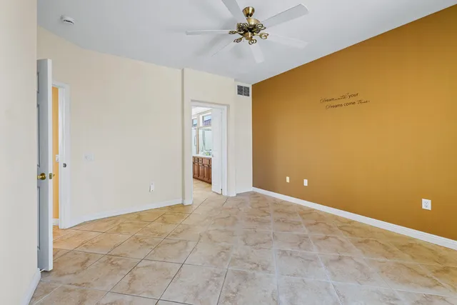 a view of a big room with chandelier fan