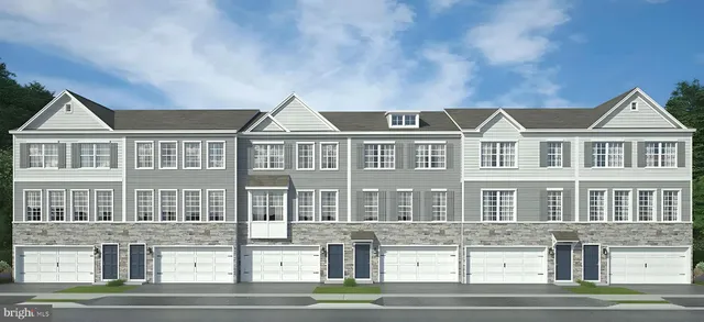 a front view of a residential apartment building with a yard