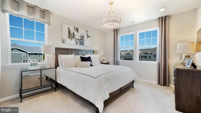 a bedroom with bed and painting on the wall