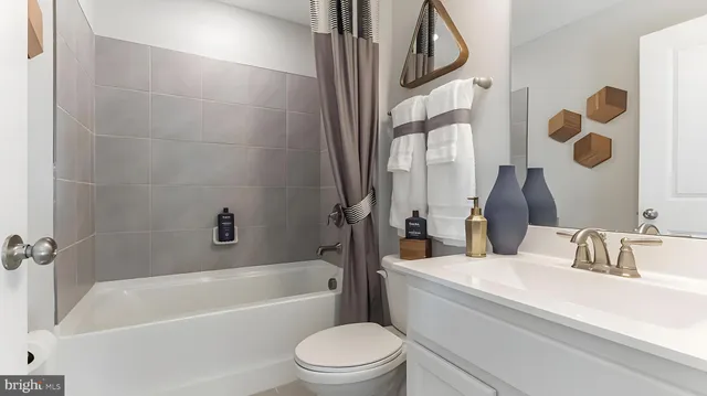 a bedroom with a bed and a potted plant on the dresser