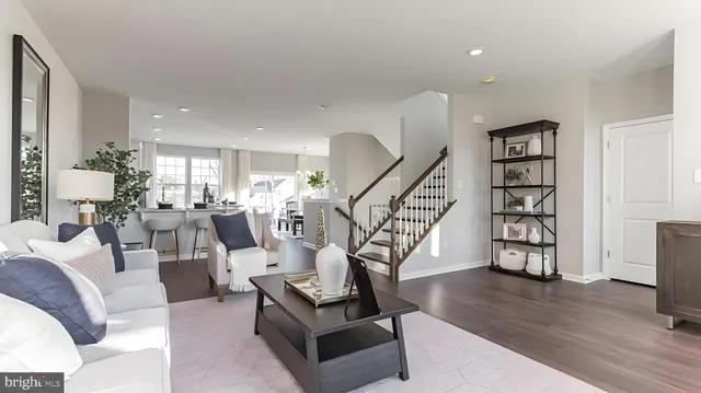 a living room with furniture and floor to ceiling windows