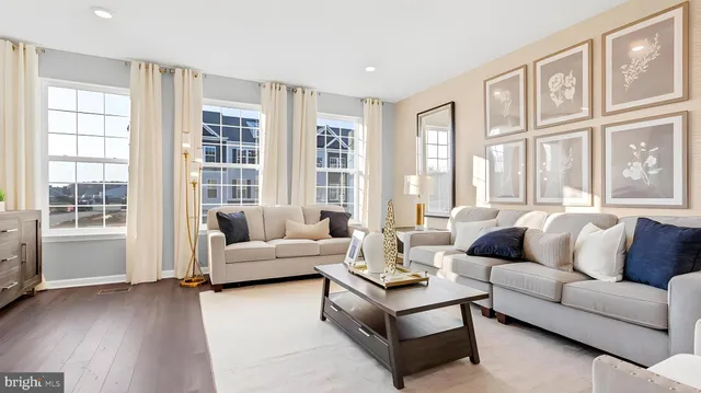 a kitchen with stainless steel appliances granite countertop a refrigerator a sink dishwasher a stove and white cabinets with wooden floor