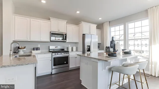 a view of living room kitchen and windows