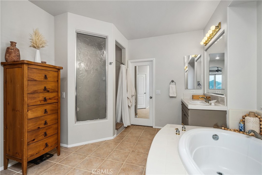 25730 Hawthorne Place Stevenson Ranch, CA 91381 - Photo 26 of 41 a bathroom with a tub sink and shower
