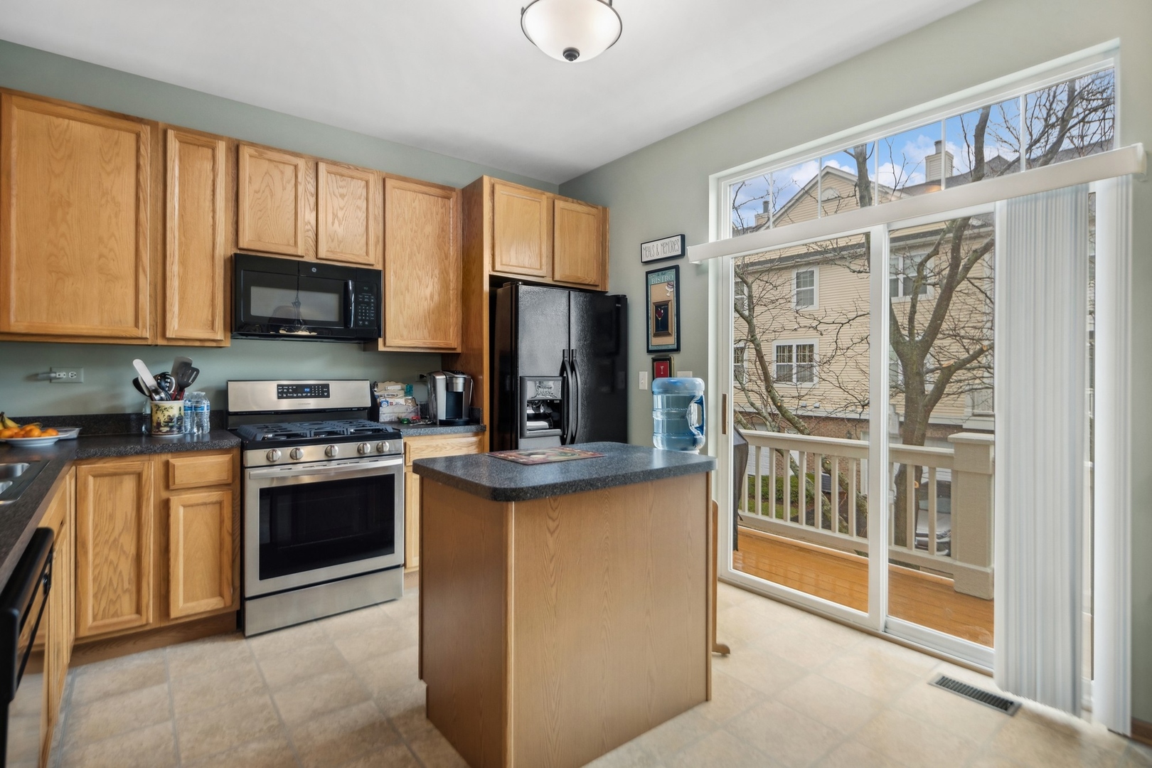 1116 Bartholdi Court Carol Stream, IL 60188 - Photo 5 of 21 a kitchen with stainless steel appliances granite countertop a stove top oven a sink and a refrigerator
