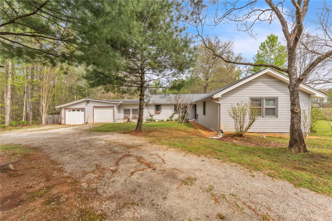 This charming home offers a spacious garage and a serene, tree-lined setting for peaceful living.