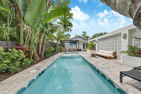 a view of house with swimming pool outdoor seating
