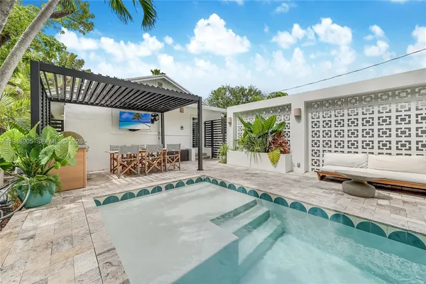 a swimming pool with potted plants and big yard