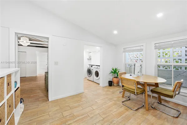 a living room with furniture a dining table and chairs