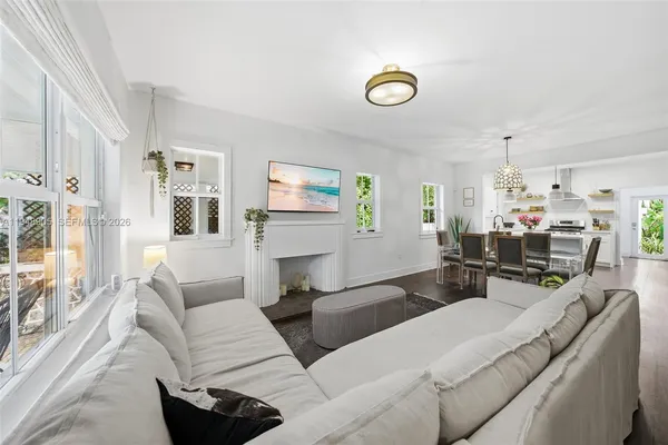 a living room with furniture and a chandelier