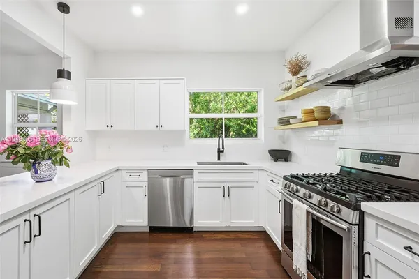 a kitchen with cabinets wooden floor and a sink