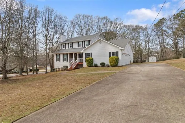 a view of a house with a yard covered in snow