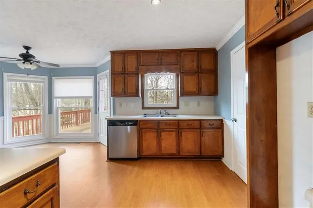 a kitchen with granite countertop a stove a sink and a microwave