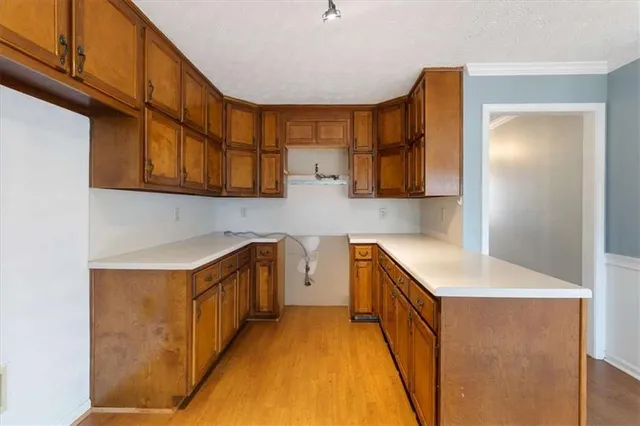 a kitchen with stainless steel appliances granite countertop a sink and cabinets