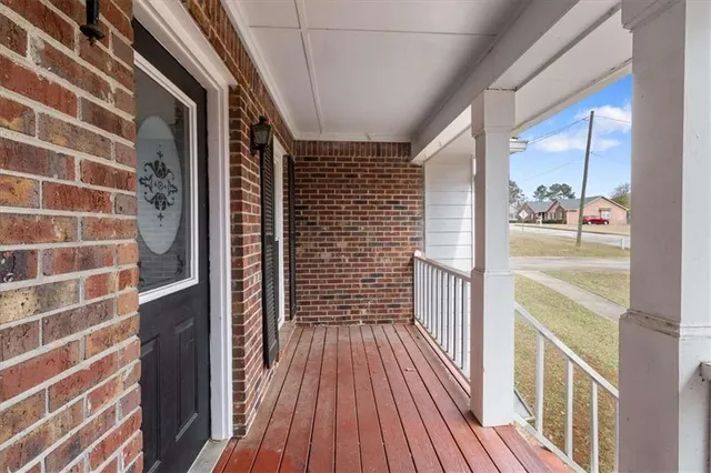 a view of a balcony with wooden floor