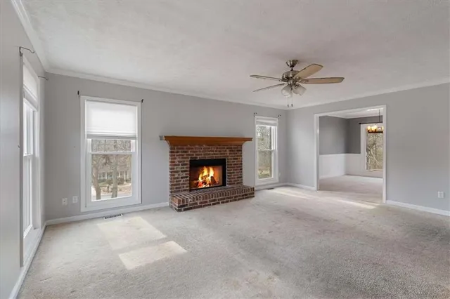 a view of a livingroom with a fireplace and a window