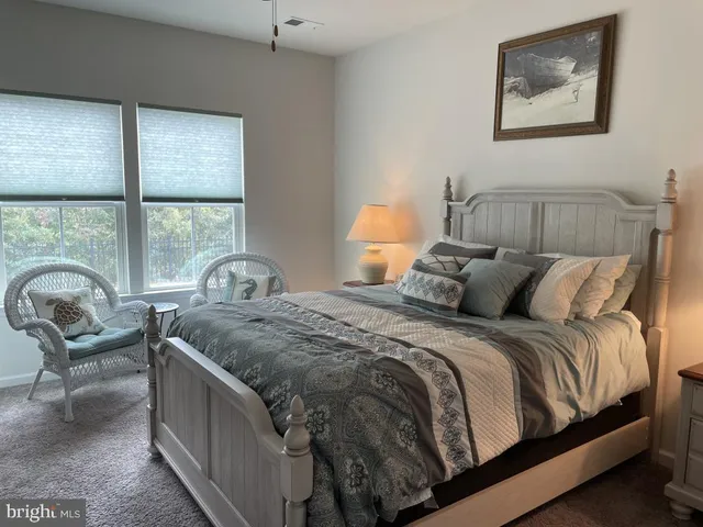 a bedroom with a bed and a large window