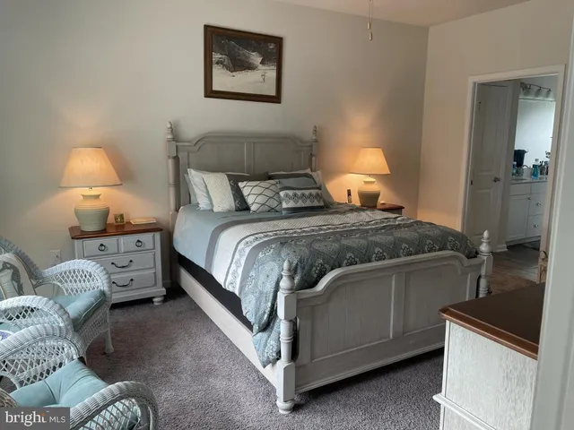 a bedroom with a bed and a lamp