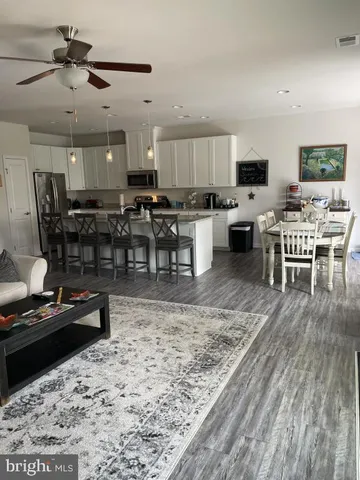 a living room with lots of furniture and kitchen view