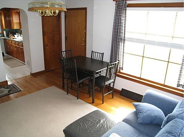 8368 Airport Road Bath, PA 18014 - Photo 4 of 10 a living room with furniture a bed and a chandelier