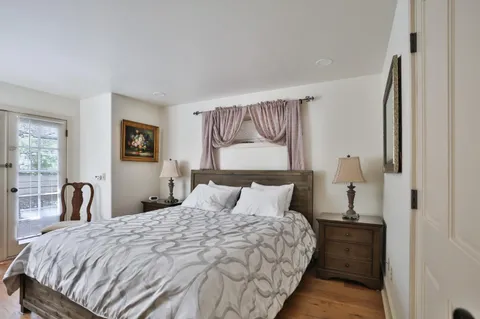 a bedroom with a bed and a large window