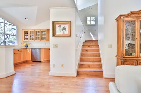 a view of a hallway with wooden floor and entryway