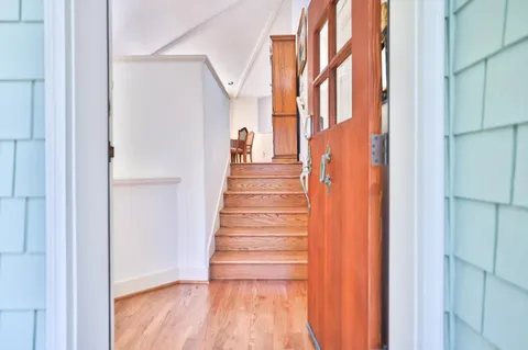 a view of entryway with wooden floor and stairs