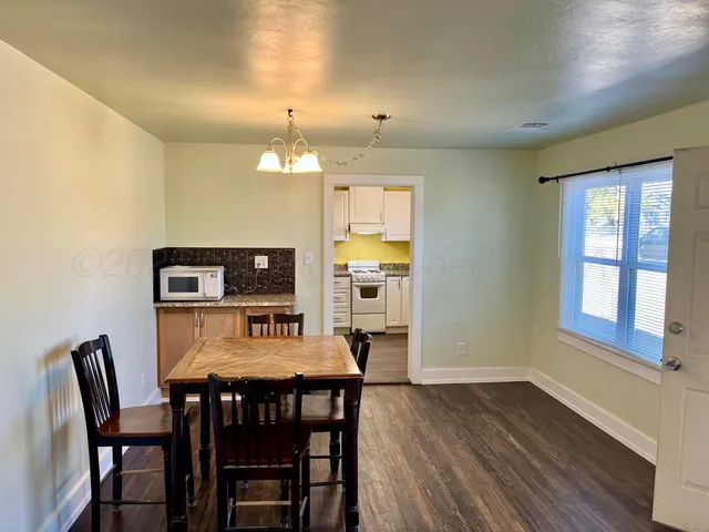 a view of a dining room with furniture and window