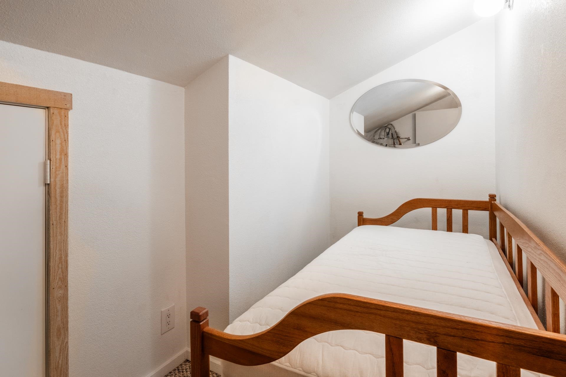 402 Snowcreek Road, Unit 402 Mammoth Lakes, CA 93546 - Photo 26 of 47 a bedroom with a bed and a chair