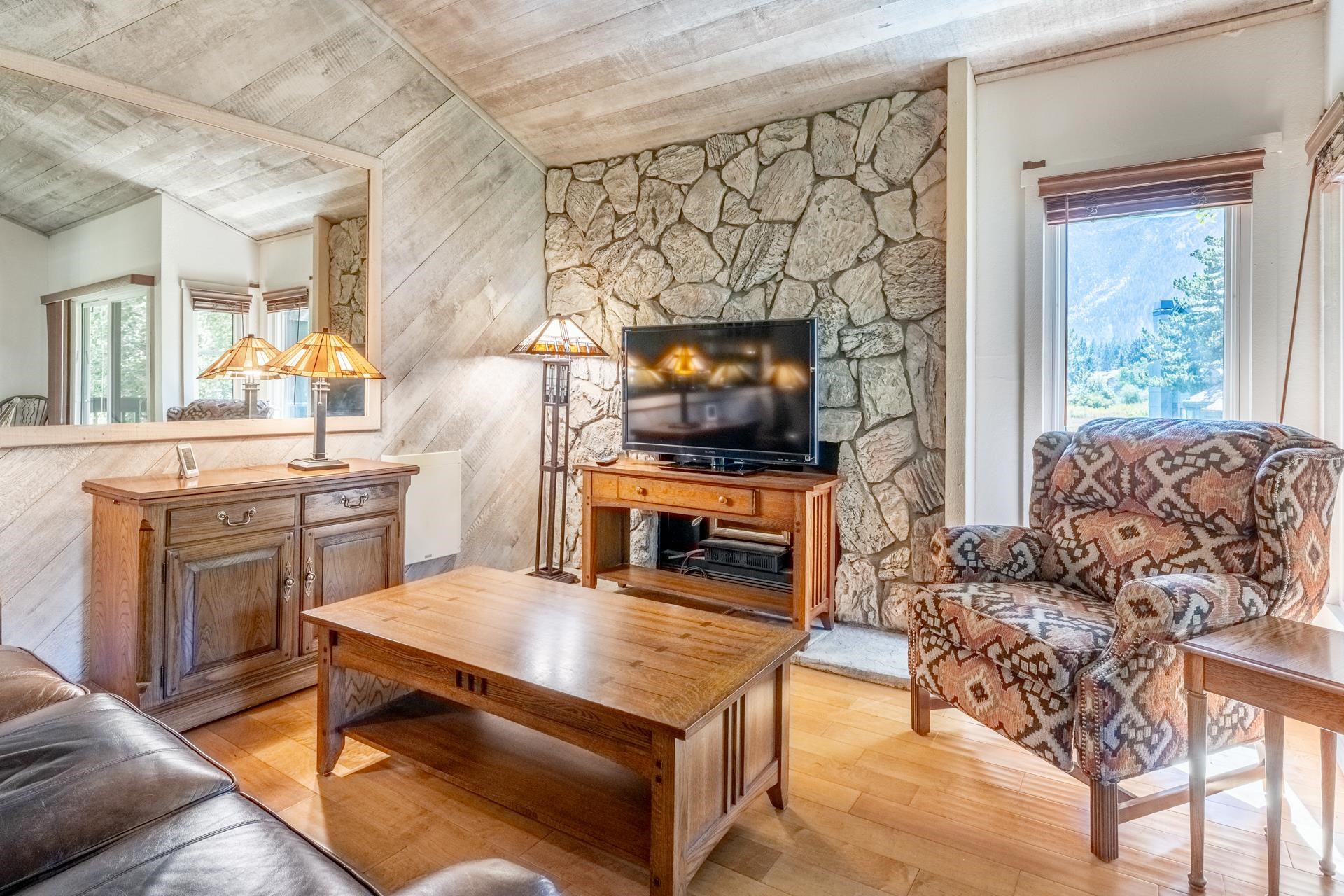 402 Snowcreek Road, Unit 402 Mammoth Lakes, CA 93546 - Photo 4 of 47 a living room with furniture and a flat screen tv