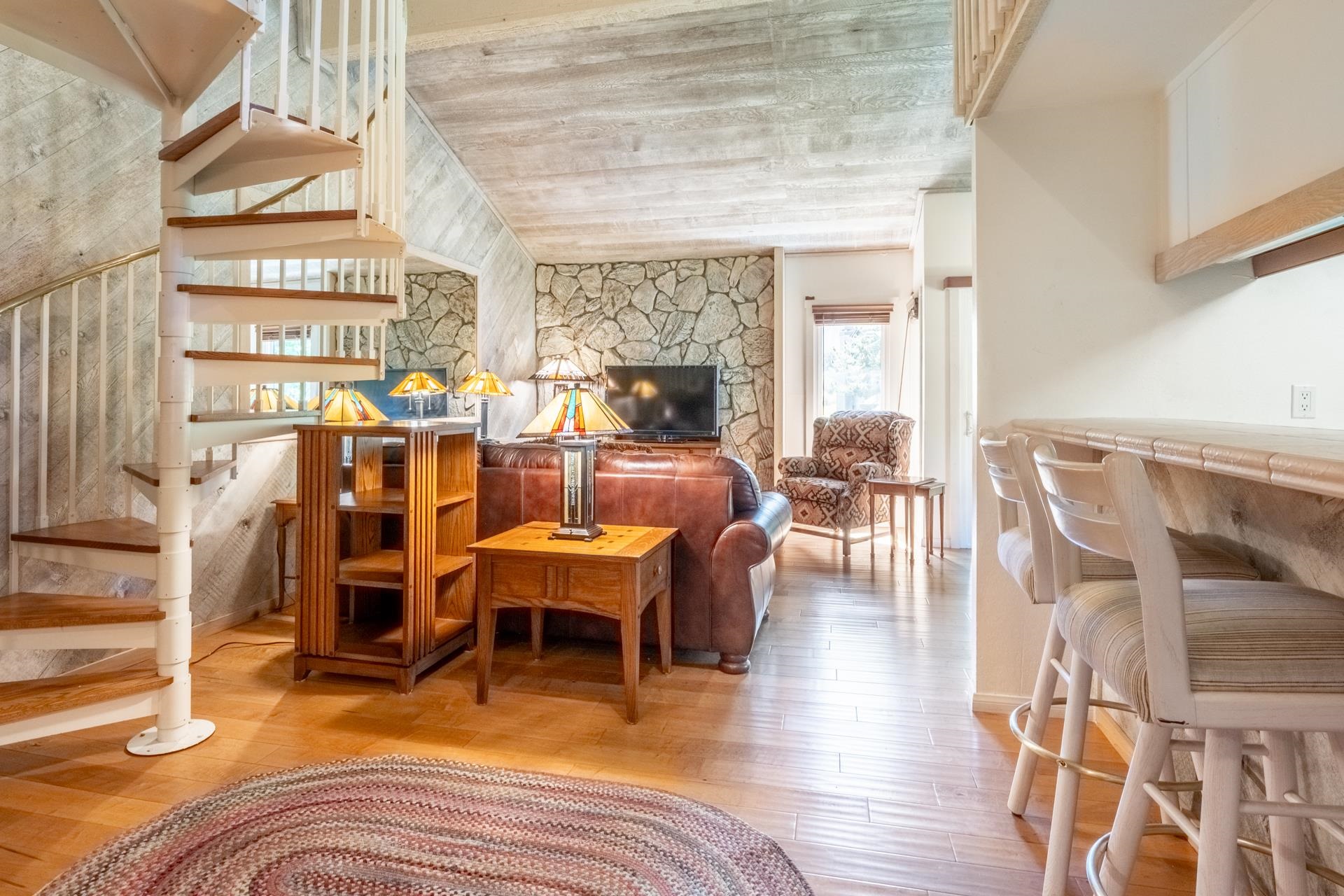 402 Snowcreek Road, Unit 402 Mammoth Lakes, CA 93546 - Photo 8 of 47 a view of a dining room with furniture a chandelier and wooden floor
