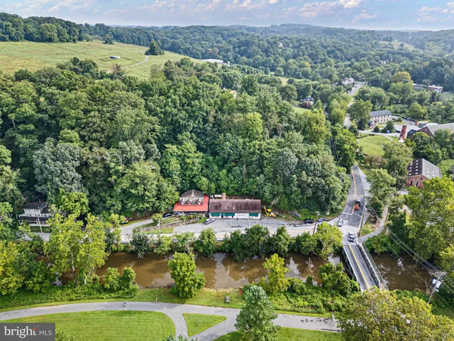 an aerial view of a house with a yard and lake view