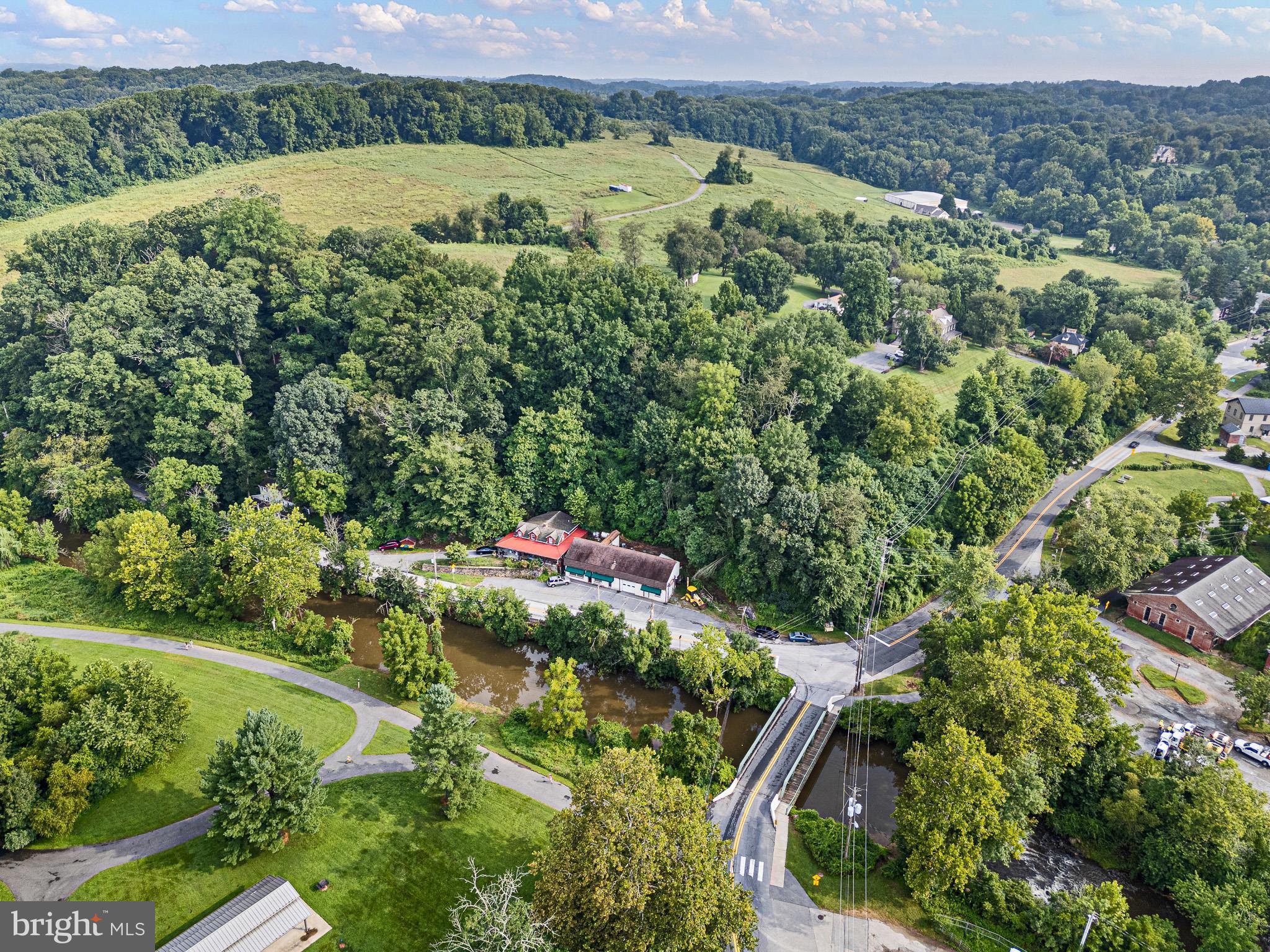 2913 Creek Road Hockessin, DE 19707 - Photo 2 of 39 a view of a lake with a house in the background