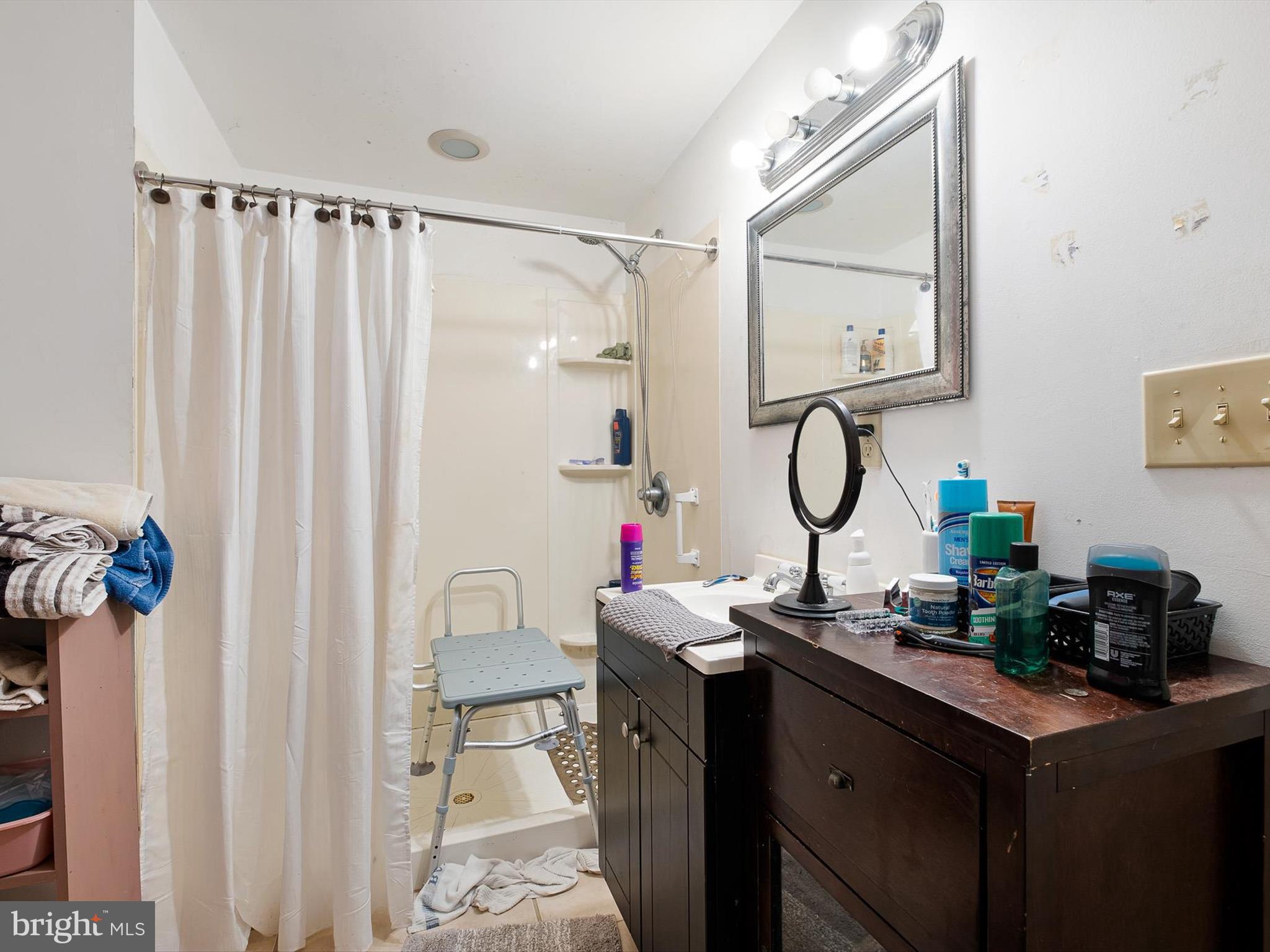 2913 Creek Road Hockessin, DE 19707 - Photo 34 of 39 a room with a sink vanity mirror and a furniture