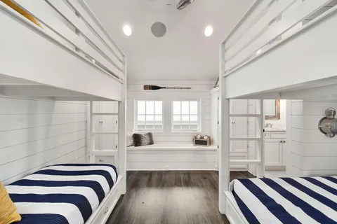 a bedroom with a bed a rug and ceiling fan