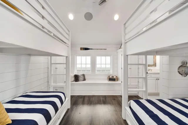 a bedroom with a bed a rug and ceiling fan