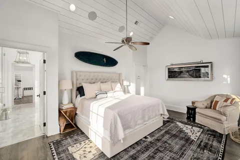 a spacious bathroom with a tub sink and mirror