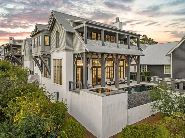 a front view of a house with porch and furniture