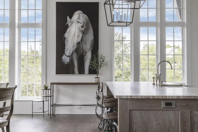 a kitchen with a table chairs and white cabinets