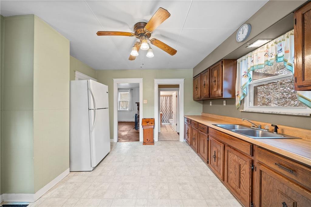 1341 Scrubgrass Road Carnegie, PA 15106 - Photo 8 of 21 a kitchen with stainless steel appliances granite countertop a refrigerator and a sink