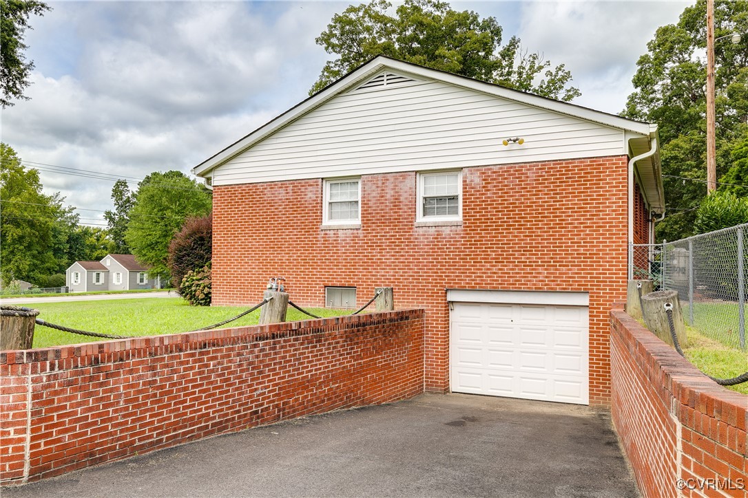 9800-9808 Reams Road North Chesterfield, VA 23236 - Photo 15 of 50 a view of a house with a yard and garage