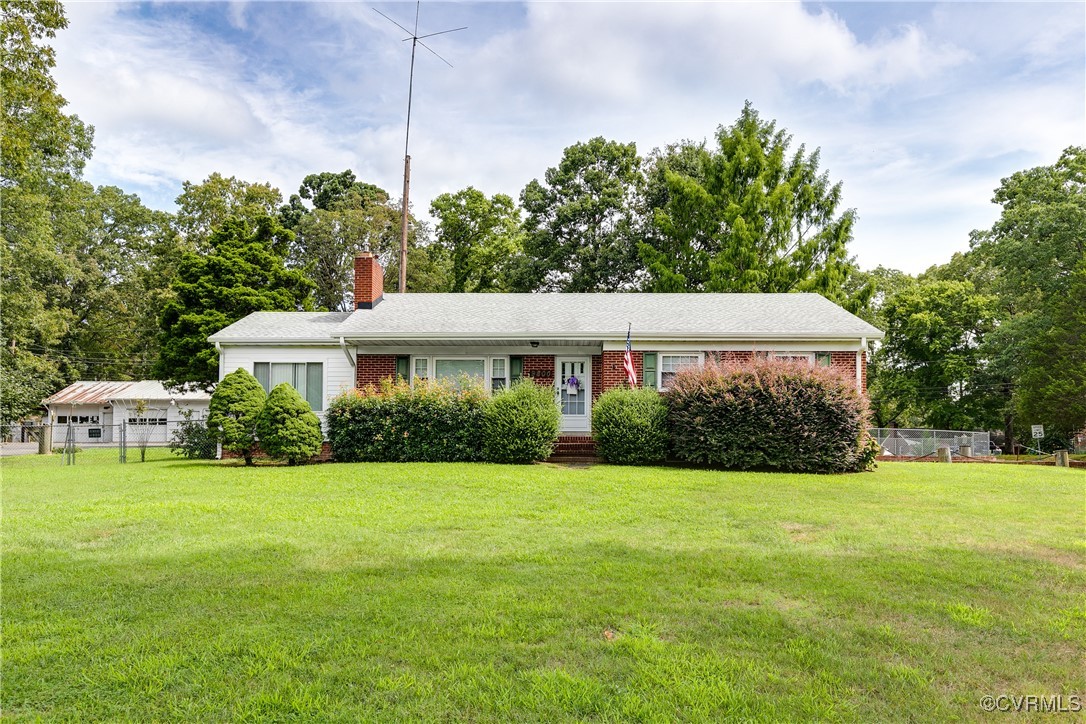 9800-9808 Reams Road North Chesterfield, VA 23236 - Photo 2 of 50 a front view of a house with yard and green space