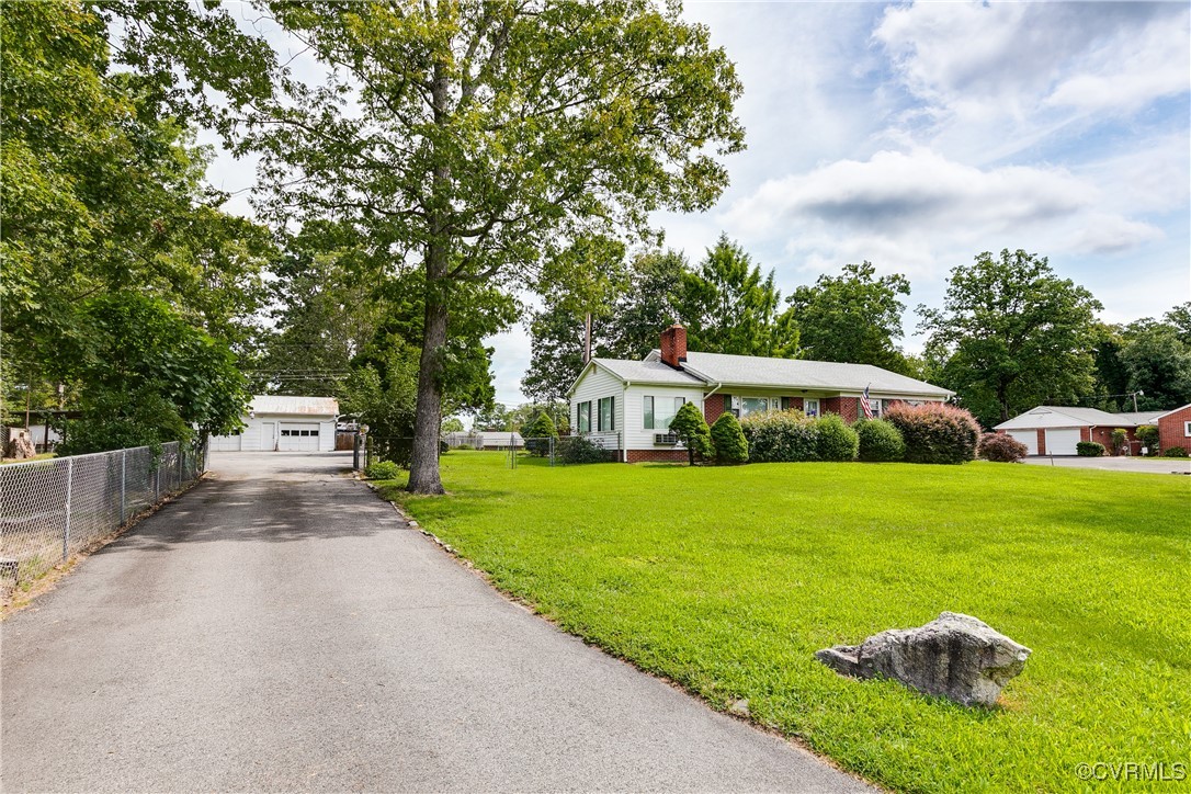 9800-9808 Reams Road North Chesterfield, VA 23236 - Photo 4 of 50 a front view of a house with garden