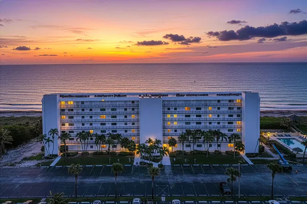 a view of building with outdoor space and ocean view