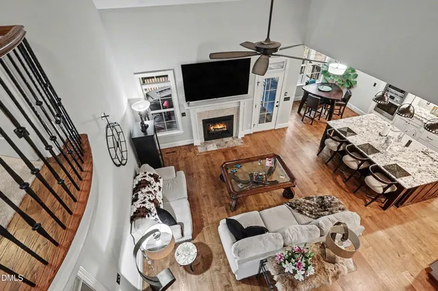 an aerial view of a residential houses with outdoor space and trees