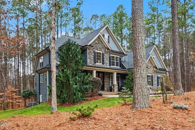 a front view of a house with a yard fire pit and outdoor seating